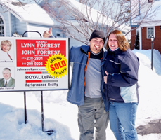 Tanya and Tyler in front of their 1st home!